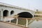 Planked footbridge along river under highway bridge across river