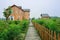 Planked footpath before European-style wooden houses in orchard