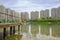 Planked pier in lake before multi-story apartments on sunny summer day