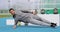 Planking fitness athlete man doing moving side plank exercises or crunches at outdoor gym training obliques muscles on