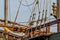 Planks, ropes, pulleys, tackle, and rigging of a replica of an old 1400\'s era sailing ship