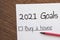 Planner of goals and plans for 2021, a sheet of paper with the inscription buy a house from to do list,