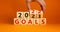 Planning 2022 goals new year symbol. Businessman turns wooden cubes and changes words `Goals 2021` to `Goals 2022`. Beautiful