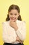 She is planning a prank. Girl school uniform smiling cunning face yellow background. Girl happy back to school. Child