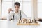 planning strategy with chess figures on an old wooden table. Businessman holding and throwing chess to . Setup