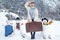 Planning winter vacations. Winter holiday. Funny woman and snowmen with suitcase.