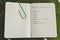 Plant-based diet green notebook with food category list on tropical leaf
