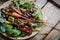 Plant based food, roasted parsley root with mushrooms and fresh baby chard leaves