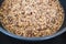 Plant-based food, tricolor quinoa seasoned with nutritionalyeast getting boiled in pot on the stove