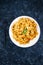 Plant-based food, vegan garlic tahini sauce pasta with mediterranean vegetables