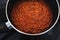 Plant-based food,  vegan lentil and textured vegetable protein ragu sauce in pot on kitchen stovetop