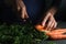 Plant, knife in hand, carrot side view