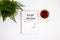 Plant, pen and notepad with 2020 review inscription on white background, new year concept