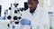 Plant science, research and black man with microscope, results and medical engineering in laboratory. Biotechnology