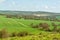 Plantation fields and farms on hilly landscape seen from the hilltop