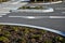 Planting at the crossroads at the crossing. recumbent junipers in a regular raster. the flowerbed is mulched with bark chips. gran