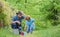 Planting flowers. Dad teaching little son care plants. Little helper in garden. Make planet greener. Growing plants