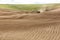 Planting potatoes in the rolling hills in the fertile farm fields of  Idaho