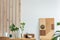 plants in small vases on long wooden dining table in bright interior