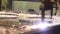The plasma cutter in operation cuts with sparks a thick metal sheet into small parts at the factory