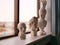 Plaster figures stand on the windowsill at art school. Greek busts