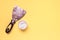 Plaster spatula and white plaster sample in a jar on yellow surface