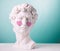Plaster statue head with pink hearts blue background