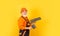 Plaster trowel spatula on yellow drywall plasterboard. Plasterer in working uniform plastering. man with spatula