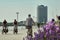 Plastered promenade on which tourists ride bicycles on the beach of TravemÃ¼nde on the Baltic Sea with a large hotel in the