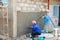 .The plasterer is applying cement to the house wall