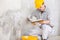 Plasterer covering a stained patch in a white wall