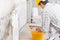 Plasterer covering a stained patch in a white wall