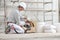 Plasterer man construction worker takes the plaster trowel from the toolbox wear gloves, hard hat and protection glasses at