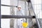 Plasterer man work holds a bucket front the wall of interior construction site wear helmet and protective gloves, ladder and