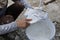 Plasterer mixing a plaster in bucket