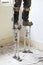 Plasterer plastering on stilts