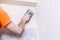 Plasterer smooths the walls with sandpaper close-up. Male hand of a worker. Stock photo