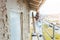 Plasterer standing on scaffolding at construction site