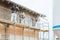 Plasterer standing on scaffolding at construction site