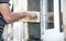 Plasterer using trowel to plastering wall near window