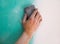 Plastering man hand sanding the plaste in drywall seam