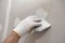 Plasterwork and wall painting preparation. close up hand of craftsman applying filling drywall patch