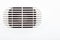 Plastic air vent in white wall ventilation grille