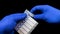 Plastic ampoules with medicine or vaccine close-up. The doctor in blue gloves examines the medicine. Macro video. Modern medicine