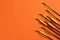 Plastic arrows on orange background. Archery sports equipment