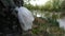 Plastic bag hanging at tree in forest. Bad ecology environment.