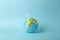 Plastic bag pollution concept. Earth globe in a plastic bag on a colored background. Plastic and waste pollution oceans, nature