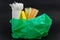 Plastic bag with single use straws plates and cutlery waste