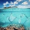 Plastic bags and bottles underwater in the ocean.