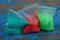 plastic bags with colored sand on the blue  table